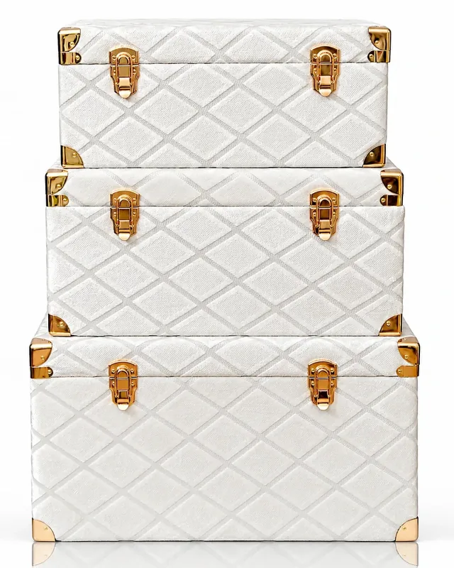 Stacked cream velvet gift trunks with gold clasps