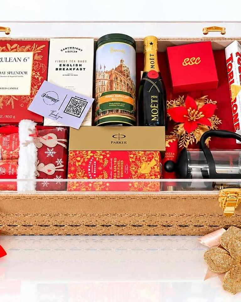 Luxury gift hamper with Moet, Harrods biscuits, a Parker gift set and festive treats