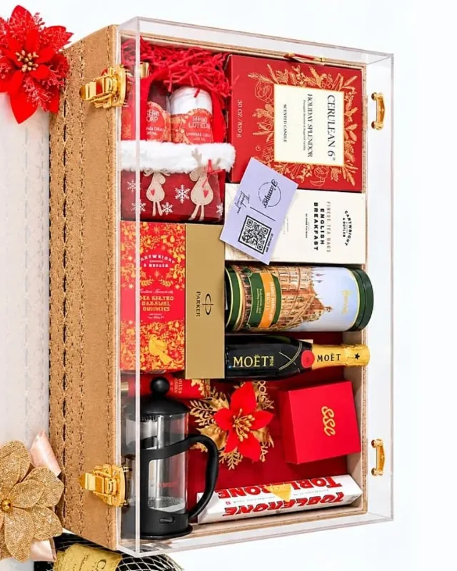 Luxury gift hamper with Moet, Harrods biscuits, a Parker gift set and festive treats